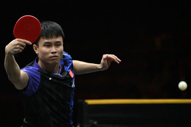 China’s Zhou Qihao hits a return to Japan’s Tomokazu Harimoto during their men’s singles match at the WTT China Smash table tennis tournament in Beijing on October 8, 2026. (Photo by ADEK BERRY / AFP)
