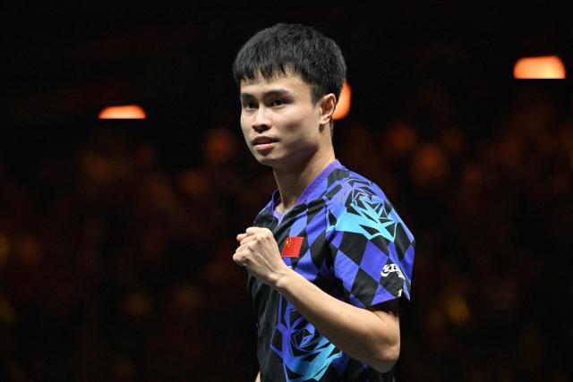 China’s Zhou Qihao reacts after his victory against Japan’s Tomokazu Harimoto during their men’s singles match at the WTT China Smash table tennis tournament in Beijing on October 8, 2026. (Photo by ADEK BERRY / AFP)