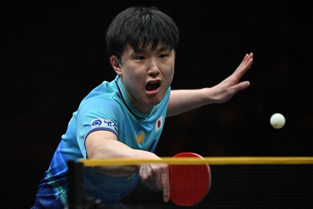 Japan’s Tomokazu Harimoto hits a return to China’s Zhou Qihao during their men’s singles match at the WTT China Smash table tennis tournament in Beijing on October 8, 2026. (Photo by ADEK BERRY / AFP)