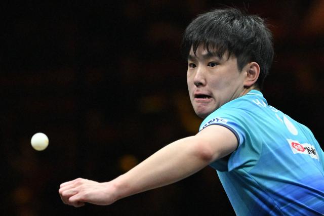 Japan’s Tomokazu Harimoto hits a return to China’s Zhou Qihao during their men’s singles match at the WTT China Smash table tennis tournament in Beijing on October 8, 2026. (Photo by ADEK BERRY / AFP)