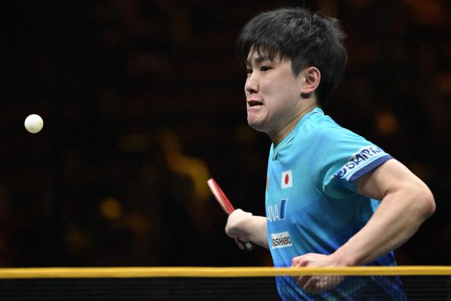 Japan’s Tomokazu Harimoto hits a return to China’s Zhou Qihao during their men’s singles match at the WTT China Smash table tennis tournament in Beijing on October 8, 2026. (Photo by ADEK BERRY / AFP)