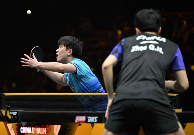 Japan’s Tomokazu Harimoto serves to China’s Zhou Qihao during their men’s singles match at the WTT China Smash table tennis tournament in Beijing on October 8, 2026. (Photo by ADEK BERRY / AFP)