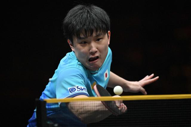 Japan’s Tomokazu Harimoto hits a return to China’s Zhou Qihao during their men’s singles match at the WTT China Smash table tennis tournament in Beijing on October 8, 2026. (Photo by ADEK BERRY / AFP)
