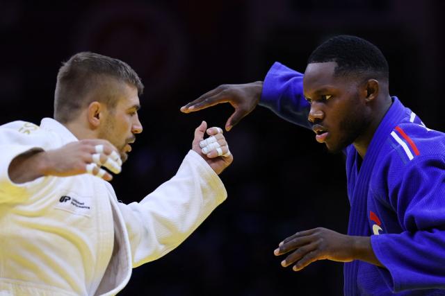 Czechia's David Klammert (white) competes against France's Maxime-Gael Ngayap Hambou in the men's under 90 kg round of 64 at the World Judo Championships in Baku on October 8, 2026. (Photo by Anne-Christine POUJOULAT / AFP)