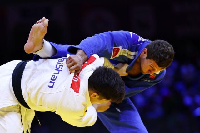 Japan's Sanshiro Murao (white) competes against Serbia's Nemanja Majdov in the men's under 90 kg quarter-final at the World Judo Championships in Baku on October 8, 2026. (Photo by Anne-Christine POUJOULAT / AFP)