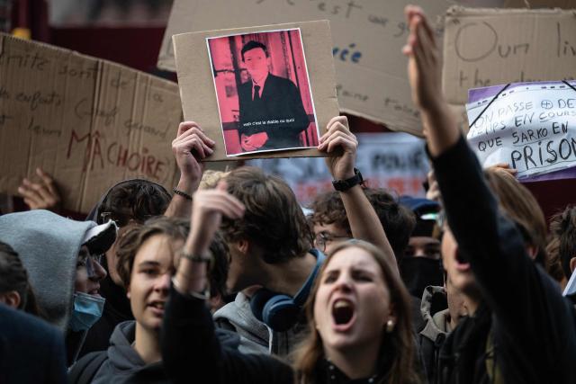 Protesters hold placards and a portrait of French Education Minister Edouard Geffray (C) during a blockade of private high-school Emilie de Rodat in Toulouse, on October 8, 2026, as part of a nationwide protest movement over learning conditions. Since late September, pupils have barred the entrances to hundreds of schools, complaining of teacher absences, overloaded timetables, dilapidated classrooms and buildings ill-adapted to rising temperatures, among other grievances. (Photo by Lionel BONAVENTURE / AFP)