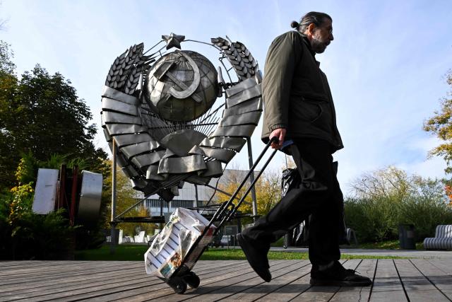 A man walks past a state emblem of the USSR at the Muzeon park of Arts in Moscow on October 8, 2026. (Photo by Igor IVANKO / AFP)