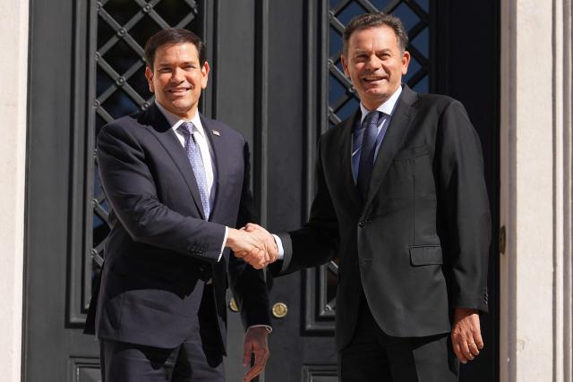 US Secretary of State Marco Rubio (L) is greeted by Portugal's Prime Minister Luis Montenegro prior to their meeting at the Sao Bento Palace in Lisbon on October 8, 2026. The US Secretary of State if on the last leg of a three-country European tour. (Photo by Mark Schiefelbein / POOL / AFP)