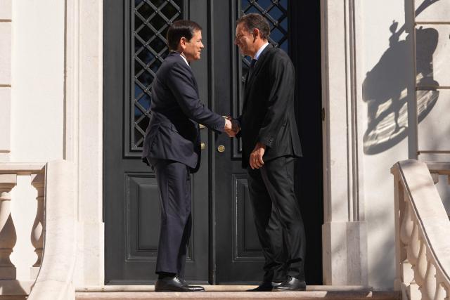 US Secretary of State Marco Rubio (L) is greeted by Portugal's Prime Minister Luis Montenegro prior to their meeting at the Sao Bento Palace in Lisbon on October 8, 2026. The US Secretary of State if on the last leg of a three-country European tour. (Photo by Mark Schiefelbein / POOL / AFP)