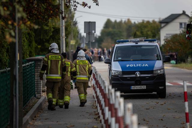 Police and other first responders work at the scene where a 15-year-old fatally stabbed the caretaker of his former school and wounded two other adults at the John-Paul II primary school in Leszczydol-Nowiny, Poland, on October 8, 2026, a day after a similar knife attack wounded nine in a Polish high school, police said. Police arrested the boy after the attack at the John-Paul II primary school in Leszczydol-Nowiny, a small town 70 kilometres (40 miles) northeast of Warsaw, a police spokesperson told AFP. (Photo by Wojtek RADWANSKI / AFP)