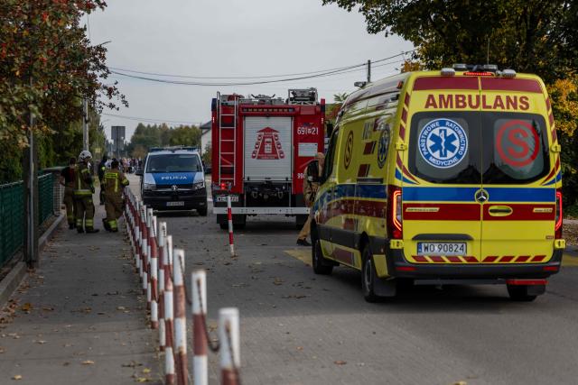 Police and other first responders work at the scene where a 15-year-old fatally stabbed the caretaker of his former school and wounded two other adults at the John-Paul II primary school in Leszczydol-Nowiny, Poland, on October 8, 2026, a day after a similar knife attack wounded nine in a Polish high school, police said. Police arrested the boy after the attack at the John-Paul II primary school in Leszczydol-Nowiny, a small town 70 kilometres (40 miles) northeast of Warsaw, a police spokesperson told AFP. (Photo by Wojtek RADWANSKI / AFP)