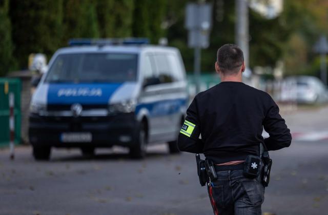 A policeman works at the scene where a 15-year-old fatally stabbed the caretaker of his former school and wounded two other adults at the John-Paul II primary school in Leszczydol-Nowiny, Poland, on October 8, 2026, a day after a similar knife attack wounded nine in a Polish high school, police said. Police arrested the boy after the attack at the John-Paul II primary school in Leszczydol-Nowiny, a small town 70 kilometres (40 miles) northeast of Warsaw, a police spokesperson told AFP. (Photo by Wojtek RADWANSKI / AFP)