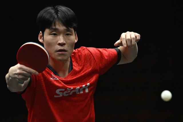 South Korea’s Jang Woo-jin hits a return to France’s Alexis Lebrun during their men’s singles match at the WTT China Smash table tennis tournament in Beijing on October 8, 2026. (Photo by ADEK BERRY / AFP)