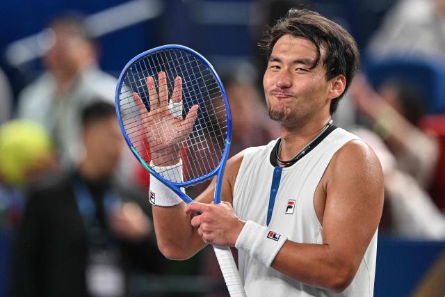 China's Bu Yunchaokete celebrates after beating France's Luca Van Assche in their men's singles match at the Shanghai Masters tennis tournament in Shanghai on October 8, 2026. (Photo by Hector RETAMAL / AFP)