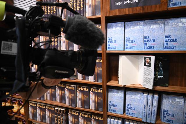 A book of 2026 Nobel Prize in Literature laureate Canadian writer Anne Carson is filmed by a TV crew at the S. Fischer publishing house's booth at the 78th Frankfurt book fair, the world's biggest trade fair for books, in Frankfurt am Main, western Germany on October 8, 2026. From October 7 to 11, 2026, publishing experts will meet up with partners from the technology and creative industries such as film and games at one of the worlds leading venues for printed and digital content with the Czech republic as guest of honour. (Photo by Kirill KUDRYAVTSEV / AFP)