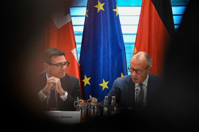 British Prime Minister Andy Burnham and German Chancellor Friedrich Merz (R) take part in a Business forum at the Chancellery in Berlin on October 8, 2026 . (Photo by Tobias SCHWARZ / AFP)