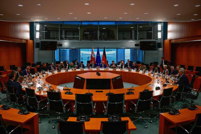 British Prime Minister Andy Burnham and German Chancellor Friedrich Merz and their delegations take part in a Business forum at the Chancellery in Berlin on October 8, 2026 . (Photo by Tobias SCHWARZ / AFP)