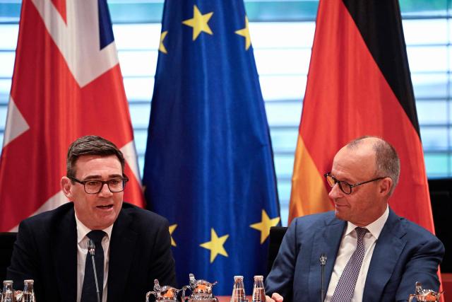 British Prime Minister Andy Burnham and German Chancellor Friedrich Merz (R) they take part in a Business forum at the Chancellery in Berlin on October 8, 2026 . (Photo by Tobias SCHWARZ / AFP)