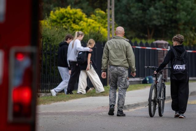 Parents and children leave the school grounds where a 15-year-old fatally stabbed the caretaker at the John-Paul II primary school in Leszczydol-Nowiny, Poland and wounded two other adults on October 8, 2026, a day after a similar knife attack wounded nine in a Polish high school, police said. Police arrested the boy after the attack at the John-Paul II primary school in Leszczydol-Nowiny, a small town 70 kilometres (40 miles) northeast of Warsaw, a police spokesperson told AFP. (Photo by Wojtek RADWANSKI / AFP)