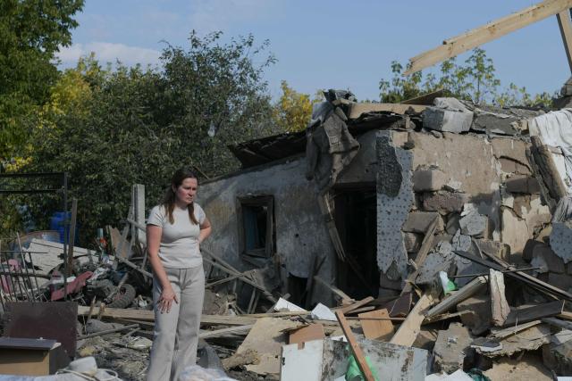 Owners, their relatives and neighbours collect belongings from a destroyed private house following an attack, which local Russian-installed officials called a Ukrainian drone strike, in Donetsk, Russian-controlled Ukraine, on October 8, 2026, amid the ongoing Russian-Ukrainian conflict. (Photo by AFP)