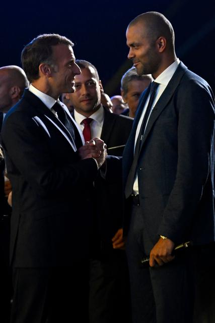 France's President Emmanuel Macron (L) shakes hands with French entrepreneur and former NBA champion Tony Parker, during the "Bpifrance Inno Generation (BIG)" event, one of Europe’s largest gatherings dedicated to entrepreneurs, in Paris on October 8, 2026. (Photo by JULIEN DE ROSA / POOL / AFP)