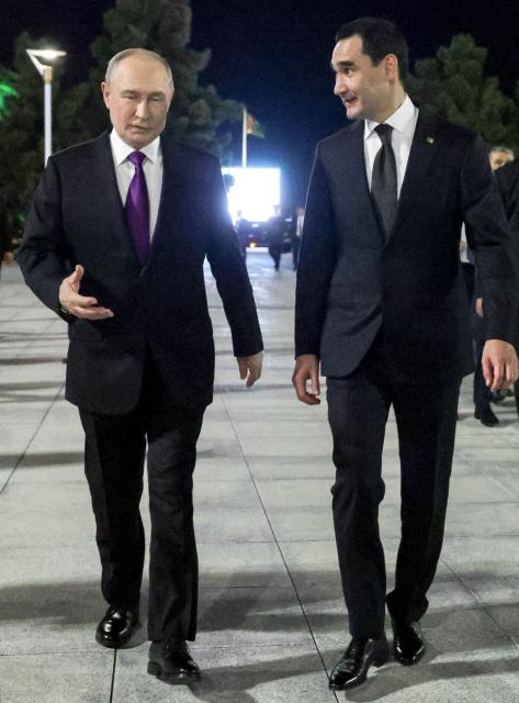 In this pool photograph distributed by the Russian state agency Sputnik, Russia's President Vladimir Putin and Turkmen President Serdar Berdymukhamedov walk during a meeting in Turkmenbashi on October 8, 2026. (Photo by Gavriil Grigorov / POOL / AFP)