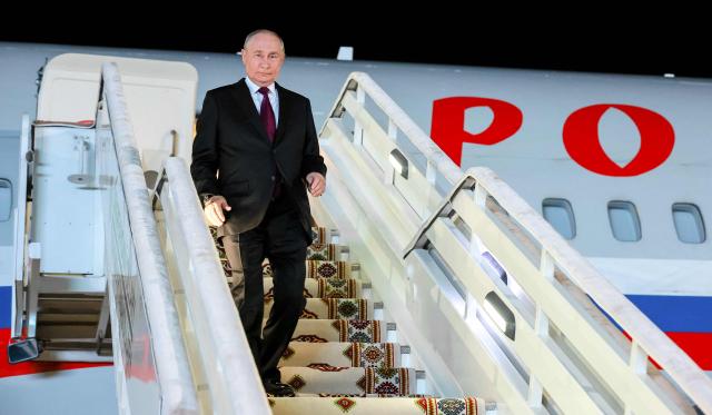In this pool photograph distributed by the Russian state agency Sputnik, Russia's President Vladimir Putin arrives at Turkmenbashi airport to attend the summit of the heads of state of the Commonwealth of Independent States (CIS), in Turkmenbashi on October 8, 2026. (Photo by Vladimir SMIRNOV / POOL / AFP)