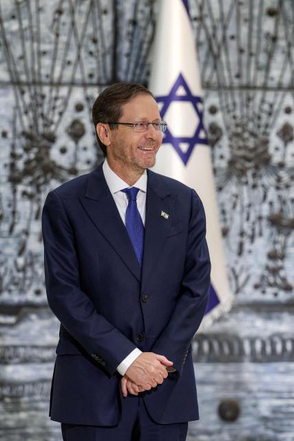 Israel's President Isaac Herzog looks on during a ceremony to award six Israeli passengers of Flydubai Flight 1073 with the Presidential Award for Civilian Heroism at the presidential residence in Jerusalem on October 8, 2026. (Photo by Ilia YEFIMOVICH / AFP)