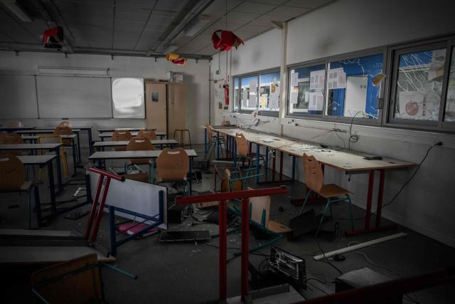 Overturned desks and chairs, broken glass and damaged computer equipment litter a classroom of "Les Iris" high school in Lormont nnear Bordeaux, southwestern France, on October 8, 2026, after youths ransacked part of the school, stealing around ten computers and setting fire to a stockpile of paper, according to the headteacher. Since late September, pupils have barred the entrances to hundreds of schools, complaining of teacher absences, overloaded timetables, dilapidated classrooms and buildings ill-adapted to rising temperatures, among other grievances. (Photo by Philippe LOPEZ / AFP)