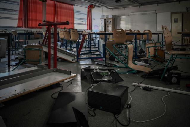 Overturned desks and chairs, broken glass and damaged computer equipment litter a classroom of "Les Iris" high school in Lormont near Bordeaux, southwestern France, on October 8, 2026, after youths ransacked part of the school, stealing around ten computers and setting fire to a stockpile of paper, according to the headteacher. Since late September, pupils have barred the entrances to hundreds of schools, complaining of teacher absences, overloaded timetables, dilapidated classrooms and buildings ill-adapted to rising temperatures, among other grievances. (Photo by Philippe LOPEZ / AFP)