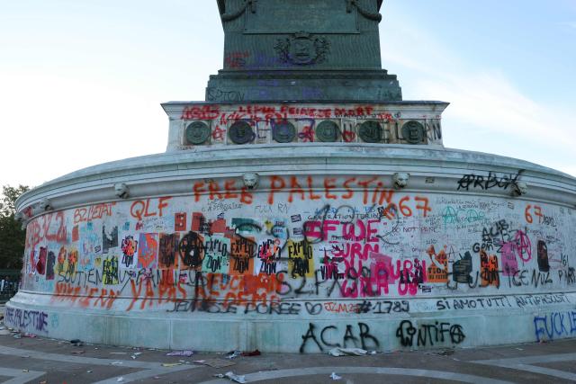 This photograph shows the base of "La colonne de Juillet" tagged by demonstrators during a demonstration of high-school students at Place de la Bastille, in Paris, on October 8, 2026, as part of a nationwide protest movement over learning conditions. Since late September, pupils have barred the entrances to hundreds of schools, complaining of teacher absences, overloaded timetables, dilapidated classrooms and buildings ill-adapted to rising temperatures, among other grievances. (Photo by Kenzo TRIBOUILLARD / AFP)