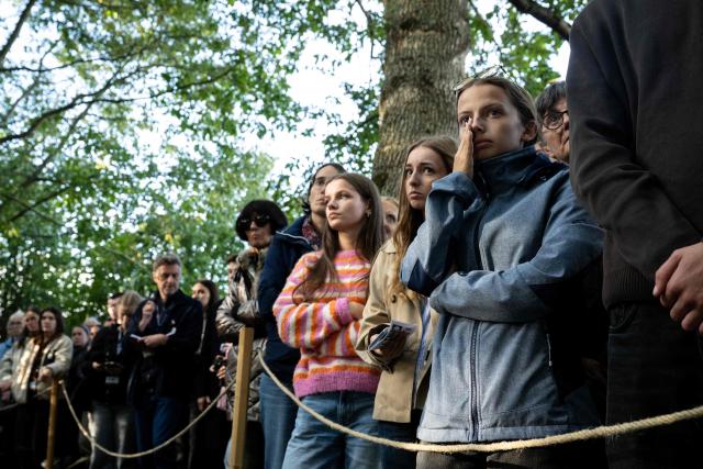 People attend a ceremony of unveiling the 2025-2026 stele as a tribute to dead journalists over the past year, as part of the 2026 edition of the "Prix Bayeux Calvados-Normandie of the war correspondants", in Bayeux, northwestern France, on October 8, 2026. (Photo by Guillaume SALIGOT / AFP)