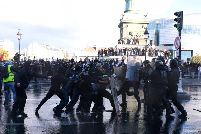 French Republican Security Corps (CRS - Compagnies Republicaines de Securite) police officers clash with protesters during a demonstration of high-school students at Place de la Bastille, in Paris, on October 8, 2026, as part of a nationwide protest movement over learning conditions. Since late September, pupils have barred the entrances to hundreds of schools, complaining of teacher absences, overloaded timetables, dilapidated classrooms and buildings ill-adapted to rising temperatures, among other grievances. (Photo by Kenzo TRIBOUILLARD / AFP)