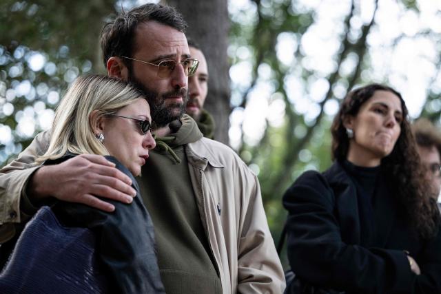 French photojournalist Adrien Vautier (2nd L) and Aida Belloulid (R), partner of killed French photographer Antoni Lallican, attend the unveiling ceremony of the 2025-2026 stele as a tribute to journalists killed in the line of duty over the past year, as part of the 2026 edition of the "Prix Bayeux Calvados-Normandie of the war correspondants", in Bayeux, northwestern France, on October 8, 2026. (Photo by Guillaume SALIGOT / AFP)