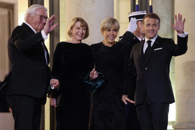 France's President Emmanuel Macron (R) and his wife Brigitte Macron (2nd R) pose with Germany's President Frank-Walter Steinmeier (L) and his wife Elke Budenbender upon their arrival ahead of a state dinner at The Elysee Presidential Palace in Paris on October 8, 2026. The dinner was held during Steinmeier's state visit to France. (Photo by Ludovic MARIN / AFP)
