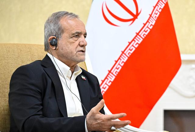 In this pool photograph distributed by the Russian state agency Sputnik, Iranian President Masoud Pezeshkian attends a meeting with Russia's President in Turkmenbashi on October 8, 2026. (Photo by Sergei BOBYLYOV / POOL / AFP)