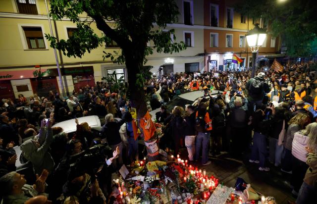 Protesters gather to pay tribute to Maricarmen Abascal in front of her apartment, the 87-year-old pensioner whose eviction triggered nationwide protests over Spain's chronic housing crisis and a political debate that culminated in early elections, during a demonstration in Madrid on October 8, 2026. Abascal became a symbol of Spain's housing market on September 23 when she was evicted from her life-long Madrid home on a stretcher after the real estate firm that owned the apartment drastically hiked the rent. (Photo by Oscar DEL POZO / AFP)
