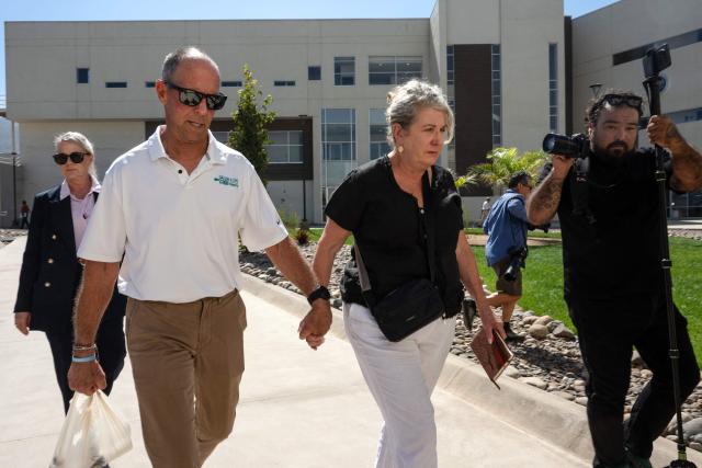 Debra (C) and Martin (L) Robinson, the parents of Australian brothers Callum and Jake Robinson, who were murdered during a surfing trip in April 2024, arrive at court for the trial of three murder suspects in Ensenada, Baja California state, Mexico, on October 8, 2026. A Mexican judge is expected to deliver a verdict on October 8 in the high-profile trial of three men accused of murdering two Australian surfers and their US friend in 2024. (Photo by Guillermo Arias / AFP)