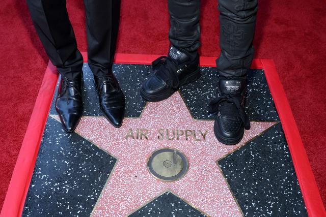 View of Honorees British singer/songwriter Graham Russell (L) and Australian musician Russell Hitchcock of duo Air Supply on their star during the Hollywood Walk Of Fame Star ceremony honoring Air Supply on October 8, 2026 in Hollywood, California. (Photo by VALERIE MACON / AFP)