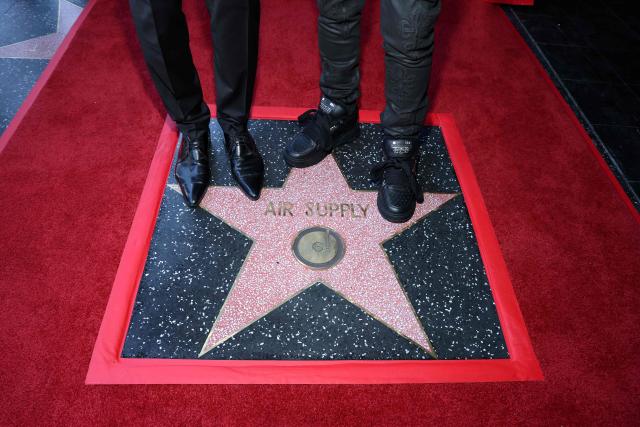 View of Honorees British singer/songwriter Graham Russell (L) and Australian musician Russell Hitchcock of duo Air Supply on their star during the Hollywood Walk Of Fame Star ceremony honoring Air Supply on October 8, 2026 in Hollywood, California. (Photo by VALERIE MACON / AFP)
