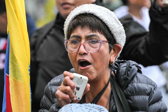 A demonstrator speaks through a megaphone during a march organized by Ecuadorean unions and social movements against the government of President Daniel Noboa in Quito on October 8, 2026. (Photo by Rodrigo BUENDIA / AFP)
