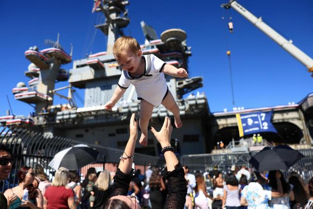 Families rejoice as the US Navy aircraft carrier USS Abraham Lincoln (CVN-72) arrives at Naval Air Station North Island in San Diego, California, on October 8, 2026. The Nimitz-class warship returned from a lengthy, difficult Iran war deployment in which multiple service members in the carrier strike group attempted suicide. The massive nuclear-powered warship left California in November 2025 for duty in the South China Sea and was rerouted to the Middle East before US-Israeli attacks on Iran that began in late February, staying at sea until a Thailand port call in early September. (Photo by David Swanson / AFP)