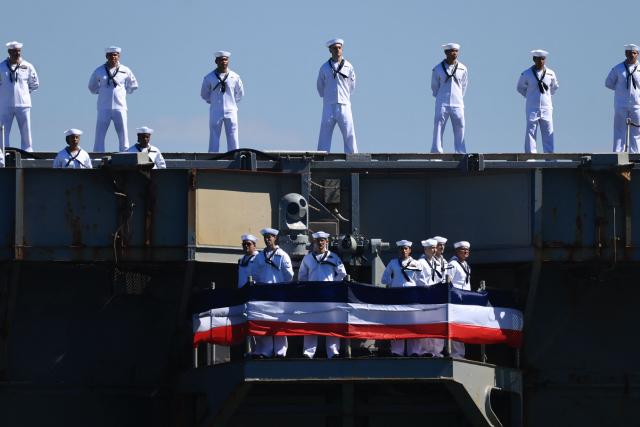 The US Navy aircraft carrier USS Abraham Lincoln (CVN-72) arrives at Naval Air Station North Island in San Diego, California, on October 8, 2026. The Nimitz-class warship returned from a lengthy, difficult Iran war deployment in which multiple service members in the carrier strike group attempted suicide. The massive nuclear-powered warship left California in November 2025 for duty in the South China Sea and was rerouted to the Middle East before US-Israeli attacks on Iran that began in late February, staying at sea until a Thailand port call in early September. (Photo by David Swanson / AFP)