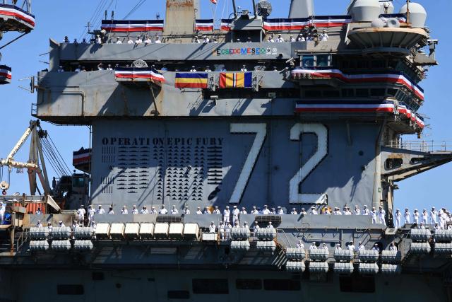 The US Navy aircraft carrier USS Abraham Lincoln (CVN-72) arrives at Naval Air Station North Island in San Diego, California, on October 8, 2026. The Nimitz-class warship returned from a lengthy, difficult Iran war deployment in which multiple service members in the carrier strike group attempted suicide. The massive nuclear-powered warship left California in November 2025 for duty in the South China Sea and was rerouted to the Middle East before US-Israeli attacks on Iran that began in late February, staying at sea until a Thailand port call in early September. (Photo by David Swanson / AFP)