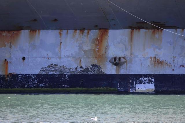Rust is seen at the waterline of US Navy aircraft carrier USS Abraham Lincoln (CVN-72) as it arrives at Naval Air Station North Island in San Diego, California, on October 8, 2026. The Nimitz-class warship returned from a lengthy, difficult Iran war deployment in which multiple service members in the carrier strike group attempted suicide. The massive nuclear-powered warship left California in November 2025 for duty in the South China Sea and was rerouted to the Middle East before US-Israeli attacks on Iran that began in late February, staying at sea until a Thailand port call in early September. (Photo by David Swanson / AFP)