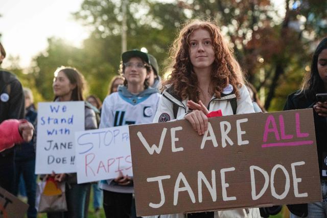 Protesters during a rally to show support for Cornell University student "Jane Doe" at Boston Common in Boston, Massachusetts on October 8, 2026. US prosecutors have reopened an investigation into an alleged 2024 gang rape at Cornell University following claims the elite university failed to properly punish the men involved. The alleged victim said in a civil lawsuit this month she was drugged with ketamine, assaulted and raped in 2024 by seven members of the Chi Phi fraternity -- a social club for male students. Cornell expelled the students involved and closed the fraternity, but the graphic details of the alleged incident have provoked public outrage and reignited a debate over sexual assault on US campuses. (Photo by JOSEPH PREZIOSO / AFP)