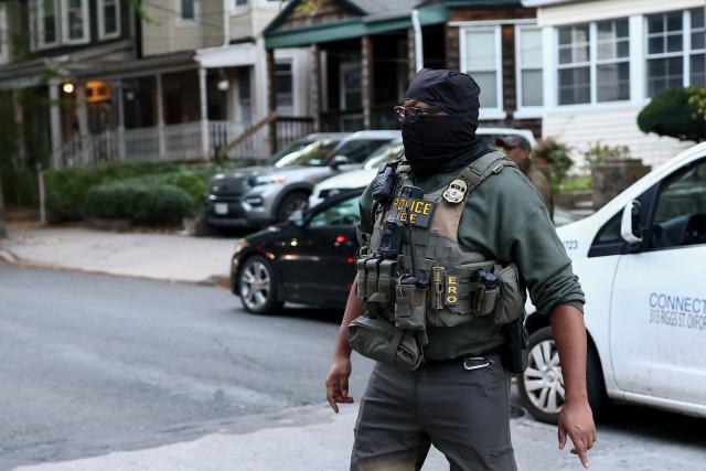 Federal agents walk near the scene where a man was shot by an Immigration and Customs Enforcement (ICE) officer during an operation in the Bronx borough of New York on October 8, 2026, according to local media and police. (Photo by CHARLY TRIBALLEAU / AFP)