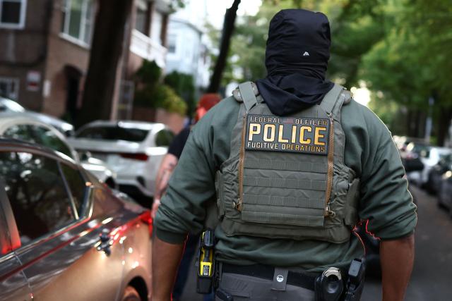 Federal agents walk near the scene where a man was shot by an Immigration and Customs Enforcement (ICE) officer during an operation in the Bronx borough of New York on October 8, 2026, according to local media and police. (Photo by CHARLY TRIBALLEAU / AFP)