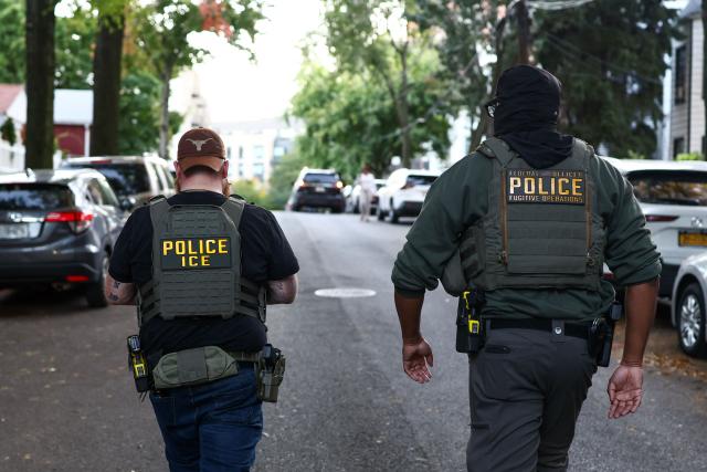Federal agents walk near the scene where a man was shot by an Immigration and Customs Enforcement (ICE) officer during an operation in the Bronx borough of New York on October 8, 2026, according to local media and police. (Photo by CHARLY TRIBALLEAU / AFP)