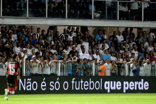 A pitchside advertisement reading “It’s not just football that loses” as part of a campaign organized by the betting companies' association is seen during the Brazilian Championship Serie A football match between Santos and Flamengo at the Vila Belmiro Stadium in Santos, Brazil on October 8, 2026. (Photo by GUILHERME DIONIZIO / AFP)